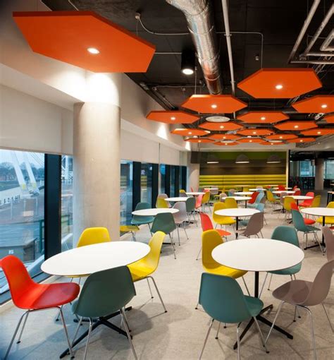 This Bright And Colourful Workplace Cafe Uses White Cafe Tables With