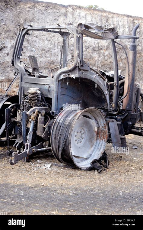 A Fire Damaged Tractor After Straw Fire In Storage Area On An East