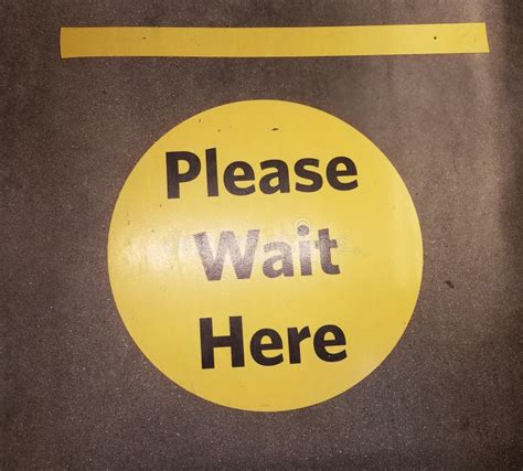 Yellow Please Wait Here Social Distancing Sign Stock Image Image Of