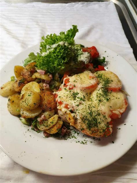 Schweinesteak mit Tomate und Käse überbacken dazu Bratkartoffel