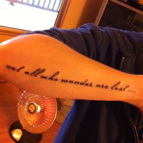 A Man With A Tattoo On His Arm That Says Not All Who Wander Are Lost