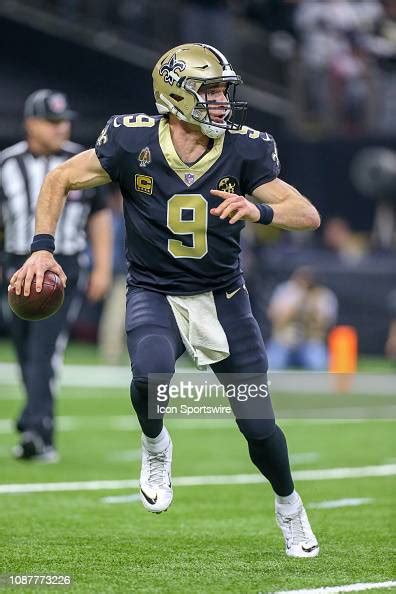New Orleans Saints Quarterback Drew Brees Rolls Out Of The Pocket