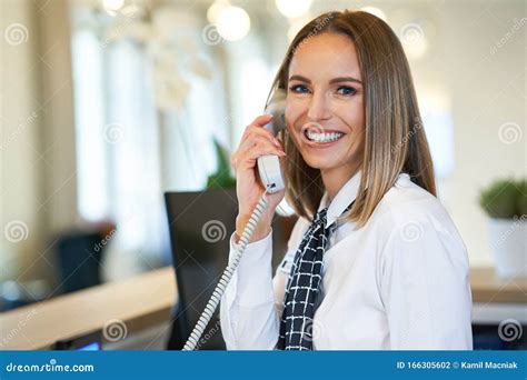 Receptionist Answering Phone At Hotel Front Desk Stock Photo Image Of