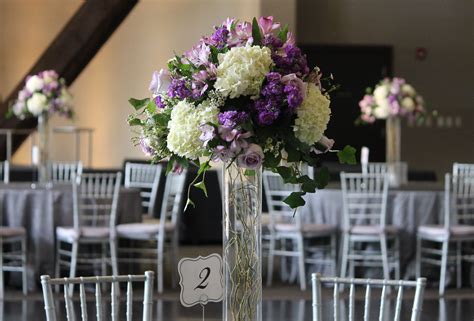 Curly Willow Fills This Glass Cylinder Topped With Ivory Hydrangea And Waxflower Plus Purple