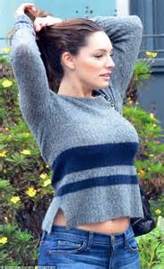 Kelly Brook Flashes A Hint Of Her Toned Tum As Her Jumper Rides Up