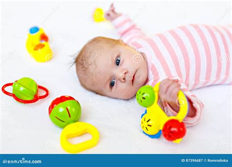 Cute Baby Girl Playing With Colorful Rattle Toys Stock Image Image Of