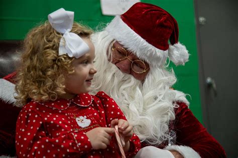 A Child Meets Santa Claus During A Holiday Event At Nara And Dvids