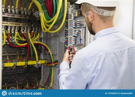 Electrician Engineer At Work Inspecting Cabling Connection Of High