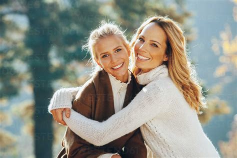 Portrait Of Happy Mother And Adult Daughter In Autumn Stock Photo