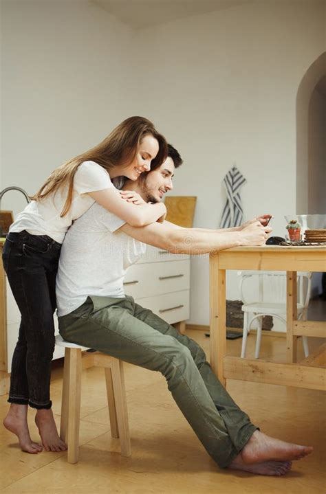 Woman Hugs Her Man From Back Tenderly Embracing Him Stock Image