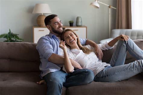 Cheerful Dreamy Married Couple Enjoying Leisure On Sofa Stock Image Image Of Home Future