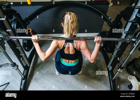 Woman Lifting Barbell In Gym Stock Photo Alamy