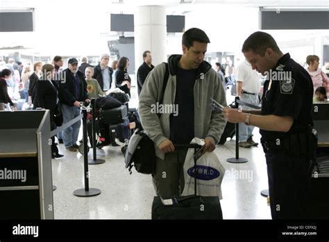 A Cbp Officer Checks A Passengers Document After Arriving At Dulles