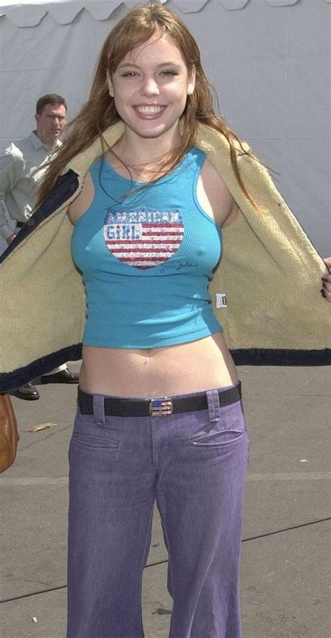 American Girl With Tattoos In Blue Shirt And Purple Pants