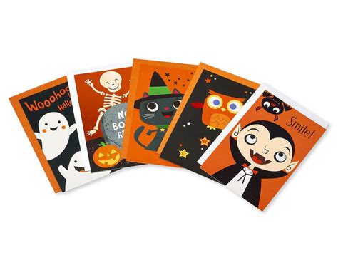 A halloween card with only halloween as text, but with a halloween skeleton carrying a pumpkin head, near a graveyard at full moon. Halloween Greeting Card Bundle For Kids, 5-Pack | American Greetings