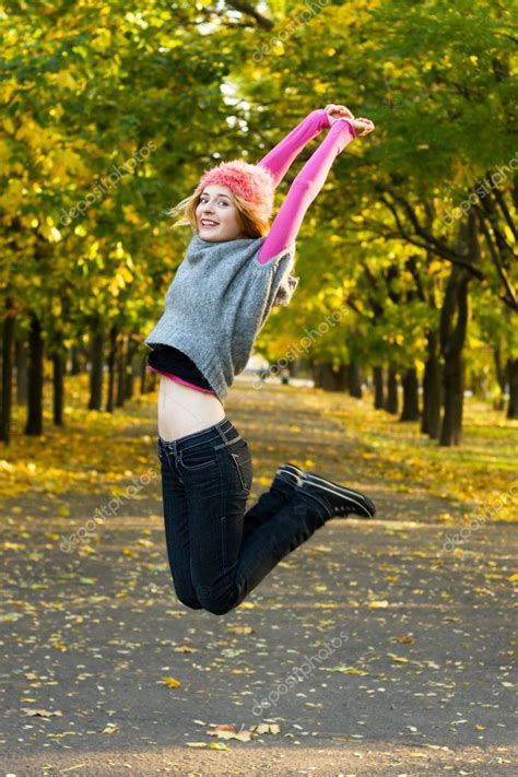 Joyful Young Woman Jumping In The Park Stock Photo By ©gdolgikh 5727203