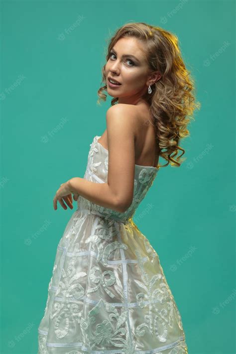 premium photo a beautiful blonde girl in a white dress turned her head and looked at the camera