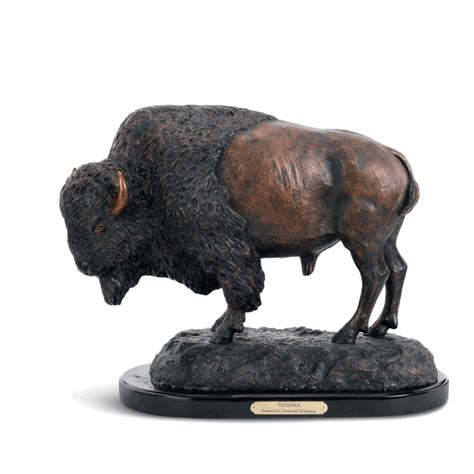 A Bronze Statue Of A Buffalo Standing On A Rock