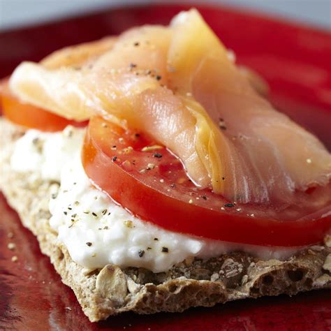 Classic additions for smoked salmon platters include bagels, cream cheese, cucumbers, dill, lemon, and a briny element such as capers or olives. Smoked Salmon Cracker Recipe | EatingWell