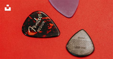 A Close Up Of A Red Guitar Picker Photo Free Plectrum Image On Unsplash
