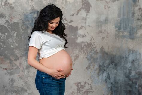 Close Up Of Pregnant Womans Big Hairy Belly On Bright Bokeh Lights