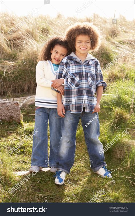 Sign up for free today! Boy And Girl Playing In Field Together Stock Photo ...