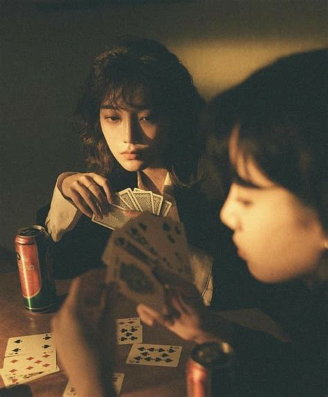 Two Women Sitting At A Table Playing Cards With Each Other And One