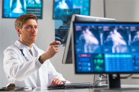 Professional Medical Doctor Working In Hospital Office Using Computer