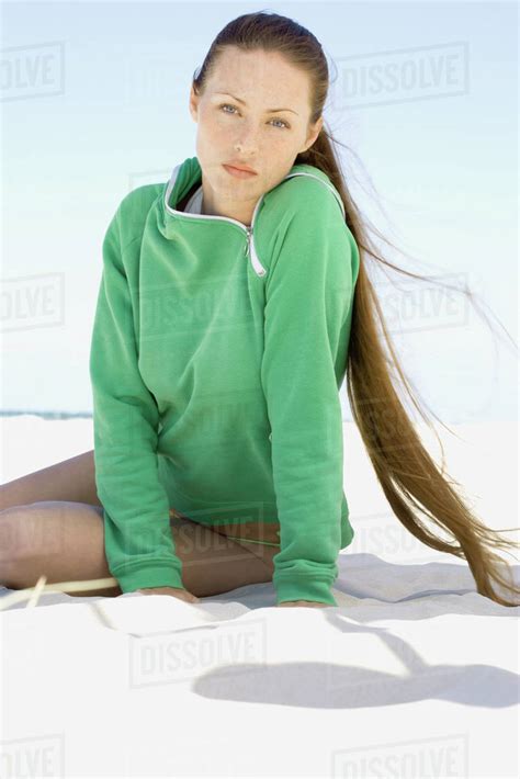Babe Woman Sitting On Beach Looking At Camera Stock Photo Dissolve