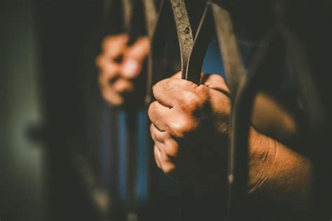 Premium Photo Cropped Hands Of Male Prisoner Holding Prison Bars