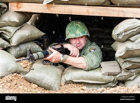 vietnam war rolling thunder re enactment us marine in bunker leaning on m16 rifle with