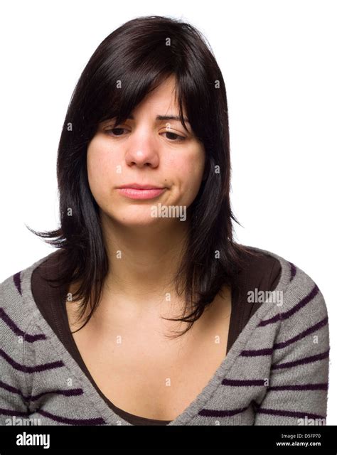 Portrait Of A Sad Young Woman Pouting While Looking Down Stock Photo