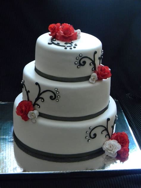 A splash of black on an otherwise white wedding cake can turn the traditional tiered design on its head. White with black/silver/red accents - Bride wanted a white ...