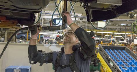 Ford assembly line workers use exoskeletal vests to lessen strain