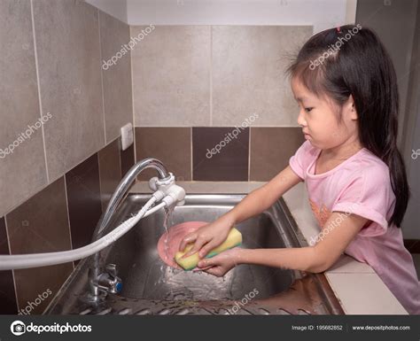 Girl Washing The Dishes