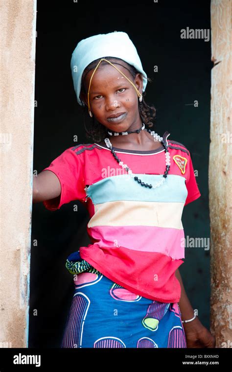 A Young Fulani Woman Pauses In The Doorframe In The Town Of Djibo In