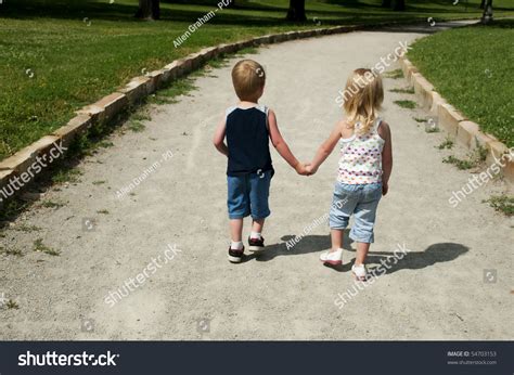 Two Young Children Holding Hands Walking Stock Photo 54703153