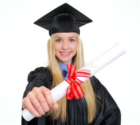 Smiling Young Woman In Graduation Gown Showing Diploma Stock Image
