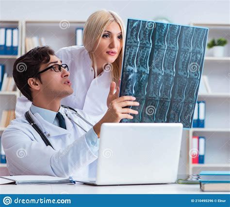 Two Doctors Examining X Ray Images Of Patient For Diagnosis Stock Photo