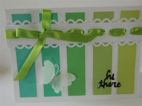 A Card With Green And White Ribbons On It