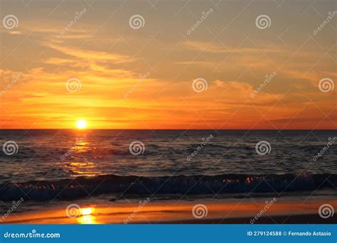 Sunset Sunrise Sunset On The Shore Of The Beach With The Sea Calm And