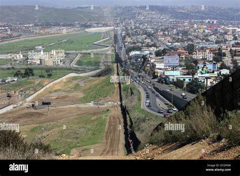 Border Fence Separating The Mexican City Of Mexicali On The Right From