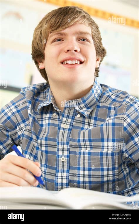 Male Teenage Student Studying In Classroom Stock Photo Alamy