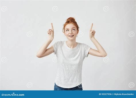 Cute Ginger Girl With Freckles Smiling Pointing Fingers Up Stock Photo