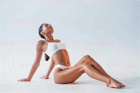 Sitting On The Floor Beautiful Woman With Slim Body In Underwear Is In The Studio