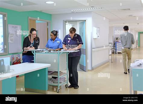 Modern Uk Hospital Ward Nurses Station Two Nurses Discuss Patient