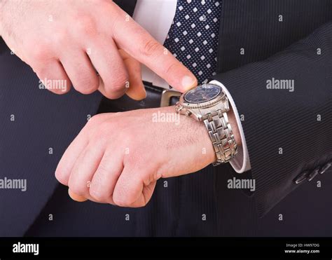 Businessman Pointing At His Wristwatch Stock Photo Alamy