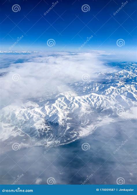 Snow Capped Mountain Range Against Blue Skies Stock Image Image Of