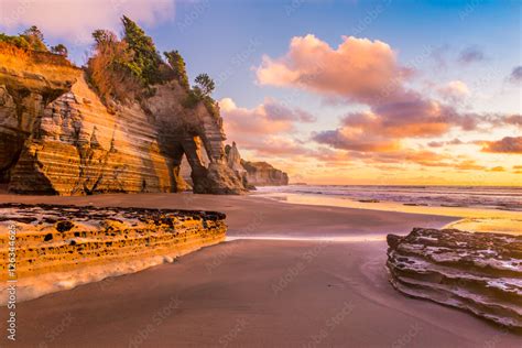 Sunset On A Rocky Beach In Taranaki District New Zealand Stock Photo
