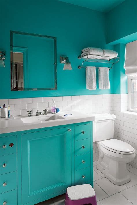 A Bathroom With Blue Walls And White Tiles On The Floor Along With A